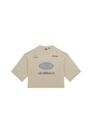 T-shirt crème coupé, à manches courtes, avec "GUESS," "LOS ANGELES, CA," et "81" brodés dans différentes couleurs.