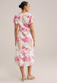 Robe midi florale avec des motifs abstraits rose, blanc et vert, manches courtes à volants et silhouette droite. Finition en tissu texturé.