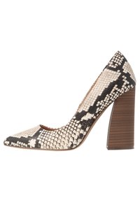 Chaussure à talon haut pour femmes avec un bout pointu, arborant un motif en serpent noir et blanc, une surface texturée et un talon en bois massif.