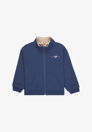Marineblaue Reißverschlussjacke mit beige gefüttertem Fleece, Vorderseiten-Taschen, gerippten Bündchen und kleinem "Est. 90" Logo auf der linken Brust.