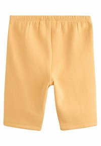 Gula bomullsshorts med elastisk midja, slät yta och en figurnära design utan fickor eller dekorationer.