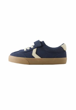 Marineblauwe kindersneaker met een klittenbandsluiting en witte veters, voorzien van een tan rubberen zool en een lichtgekleurde hielaccent.