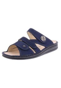 Navy blue sandals with dual hook-and-loop straps, a cushioned footbed, textured edges, and a decorative silver-tone accent circular detail.