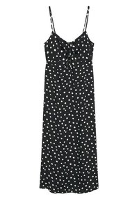 Robe sans manches noire à pois blancs, avec un nœud noué à la poitrine, design fluide et ourlet droit.