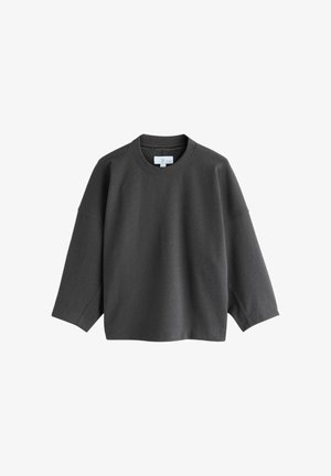Mørkegrå oversized sweatshirt med rund halsudskæring, sænkede skuldre og lange ærmer, lavet af blødt, tekstureret stof.