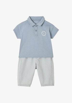 Light blue short-sleeve polo shirt with small sun graphic paired with pale blue and white striped knee-length shorts.
