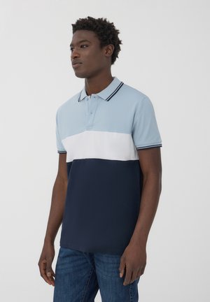 Polo in blu chiaro, bianco e blocchi di colore blu navy. Tessuto di cotone morbido con colletto a coste e maniche corte. Taglio classico.