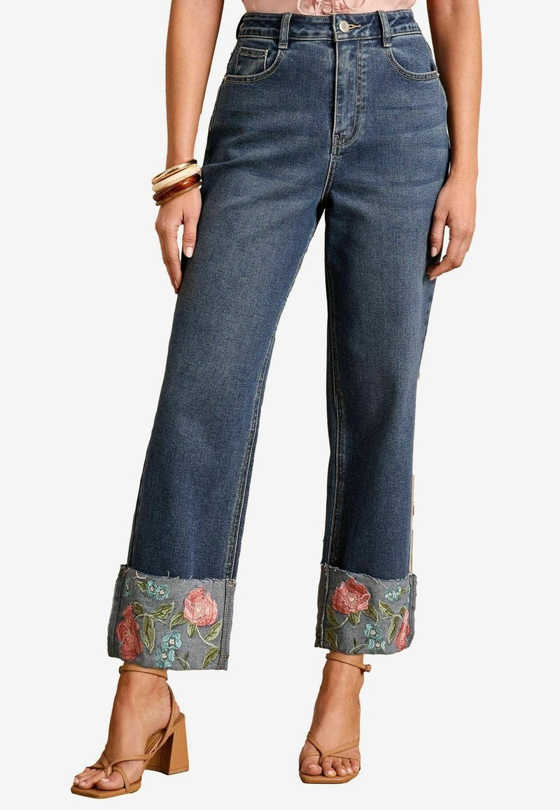 Donkerblauwe high-waisted denim jeans met een wijde pijp. Bevat versierde geborduurde bloemenmanchetten in roze en groen op een rafelige zoom.