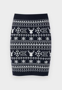 Jupe crayon en tricot présentant un fond bleu marine avec des rennes blancs, des flocons de neige et des motifs géométriques dans un tissu texturé.