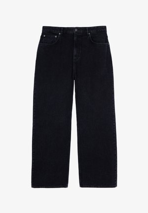 Spodnie dzwonowate z korduroyu w ciemnym niebieskim kolorze, z charakterystyczną ribbowaną fakturą, standardowym pięciopocketowym fasonem oraz metalowym zapięciem w pasie.