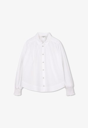 White blouse with a classic collar, long puff sleeves, and pearl-like button closures. Features textured accents on shoulders and ribbed cuffs.