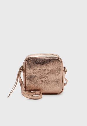 Square metallic rose gold crossbody bag with adjustable strap, embossed with "Marc Cain Since 1973" on the front.