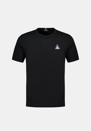 T-shirt en coton noir avec un col rond et des manches courtes. Petit logo brodé sur la zone gauche de la poitrine en bleu, rouge et blanc.