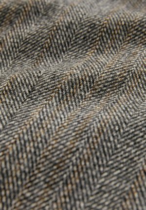 Textured woven fabric in gray tones with a herringbone pattern, featuring flecks of brown and a soft, wool-like finish.