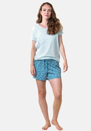 Light blue short-sleeve shirt with a v-neck, paired with blue shorts featuring a white floral pattern and an elastic waistband.