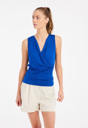 Blue sleeveless top with a draped neckline and gathered detailing, paired with beige shorts, featuring a relaxed fit and smooth texture.