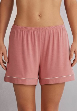Roze katoenen shorts met een zachte textuur, voorzien van een elastische tailleband en witte bies langs de boorden. Ontspannen pasvorm en een lengte tot halverwege de bovenbenen.