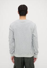 Gray sweatshirt made of cotton blend, featuring long sleeves, ribbed cuffs, and a slightly textured surface. Back view shows a crew neck design.