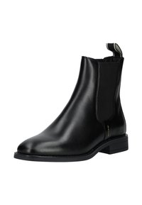 Stivale Chelsea in pelle nera con un design elegante, pannelli laterali elastici e linguetta. Presenta una punta leggermente appuntita e un tacco basso impilato.