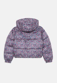 Anorak azul con capucha, cubierto de un pequeño patrón de flores y corazones en rojo, rosa y blanco, visto desde la parte de atrás.