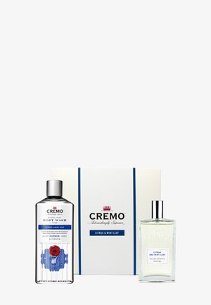 Coffret cadeau Cremo Citrus & Mint Leaf avec gel douche rafraîchissant et eau de toilette dans des flacons transparents à côté d'une boîte blanche et bleue de marque.