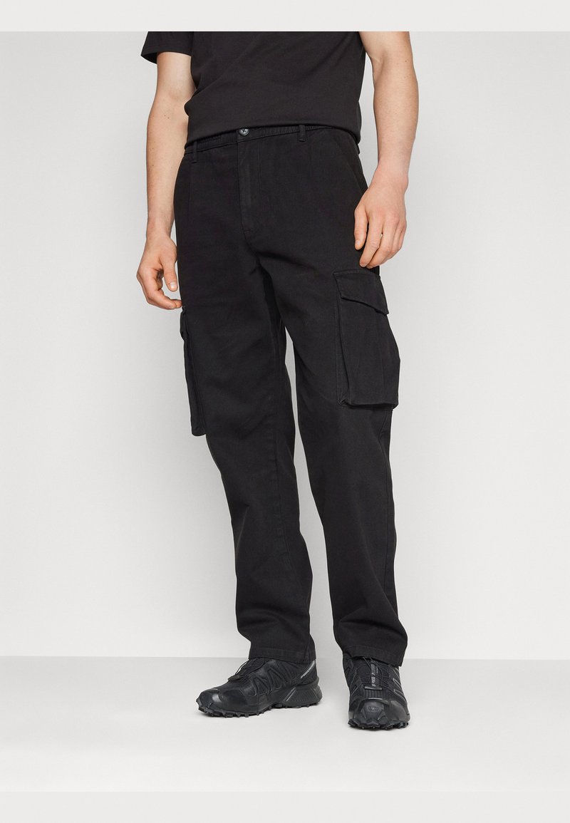 Black cargo pants with a straight fit, featuring two large side pockets and a button closure. Made of sturdy fabric with a smooth texture.