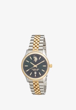 Montre-bracelet pour homme avec cadran noir, bracelet en métal or et argent, index des heures dorés, affichage de la date et logo U.S. Polo Assn. en haut au centre.