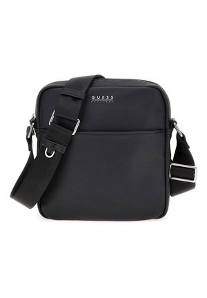 Black Guess crossbody bag with adjustable shoulder strap, front zip pocket, and textured leather finish.