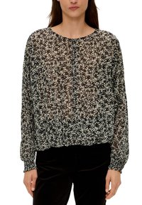 Schwarzblumenbluse mit lockerer Passform, durchsichtigem Stoff, rundem Halsauschnitt und elastischem Saum. Lange Ärmel mit gerafften Manschetten. Weißes Blumenmuster.