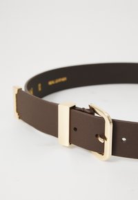 Brown leather belt with a gold-tone metallic buckle. Smooth texture, flat design, and rectangular buckle with subtle accents.