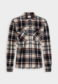 Camicia a scacchi nei toni del blu navy, marrone e crema. Realizzata in flanella con bottone anteriore, due tasche sul petto e colletto.