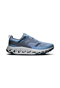Light blue running shoe with mesh upper, white cushioned sole, black accents, and distinctive holes for ventilation and flexibility.