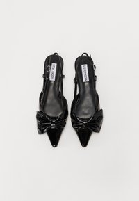 Black patent leather slingback heels with a pointed toe, featuring a bow detail on the front and adjustable ankle strap.