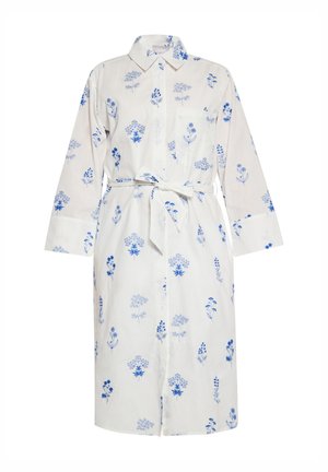 Knap-uppet skjortekjole i hvidt stof med blå blomster mønster. Har en krave, lange ærmer og et matchende bælte i taljen.