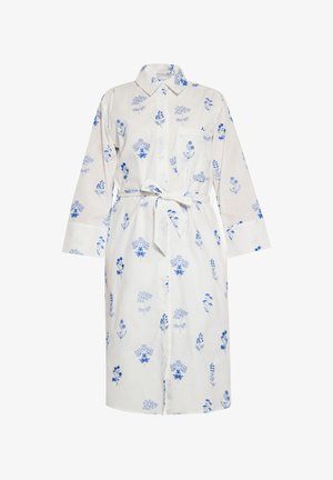 Fehér anyagú, kék virágmintás ingruha. Különleges gallérral, hosszú ujjal és derékon illő övvel rendelkezik.