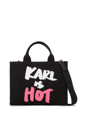 Black canvas tote bag with dual handles and a detachable shoulder strap. Features bold text "KARL is HOT" in white and pink paint-like lettering.