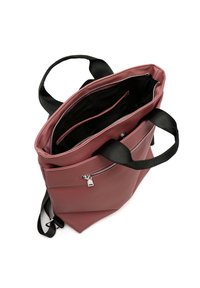 Pink faux leather bag with black fabric handles, zippered closure, and interior compartments for organization. Flat bottom for stability.