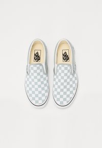 Green and white checkerboard slip-on shoes with elastic side accents and black rubber soles, featuring Vans logo on the footbed.