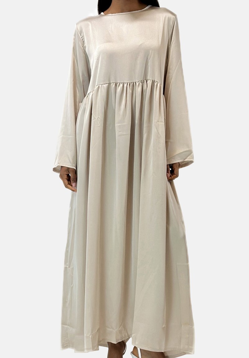 Lang, flydende kjole i et lyst beige satinmateriale med rund halsudskæring, lange ærmer og en indsnævret talje med to sidelommer.
