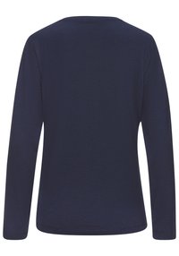 Marinblus med lång ärm och rundad halsringning. Tillverkad av mjukt bomullsmaterial med en slät yta. Inga mönster eller synlig hårdvara.