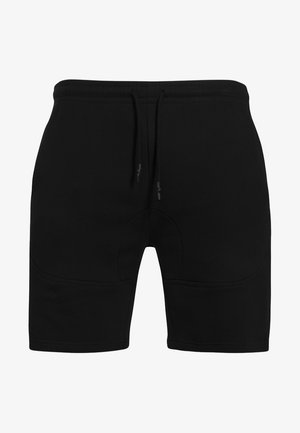 Svarta shorts i mjukt tyg, med elastisk midja och dragsko, platta sömmar och en figurnära design.