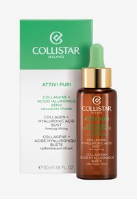 Brun glasdropperflaska med ett guldlock, grön dropper och en vit och grön låda som visar produktinformation på flera språk.