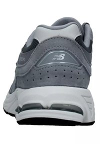 Gray athletic shoe with suede and mesh materials, featuring a padded collar, perforated details, and a white midsole with visible air cushioning.