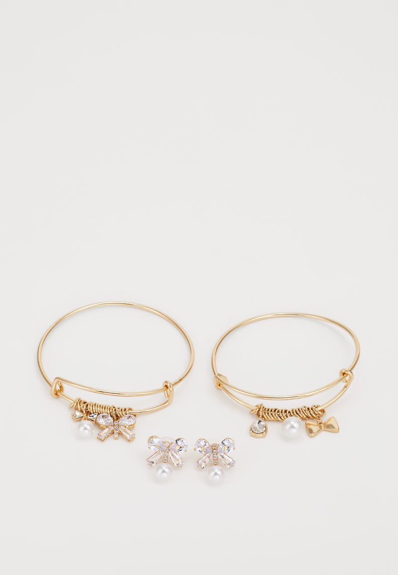 Gold hoop earrings with charms, including a pearl and bows, alongside matching stud earrings with pearls and crystal accents.