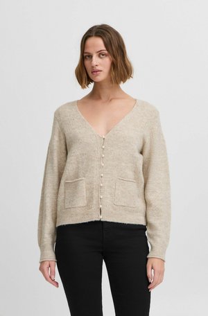 Beige knitted cardigan with a v-neck, button front, and two front pockets. Features ribbed cuffs and a relaxed fit.