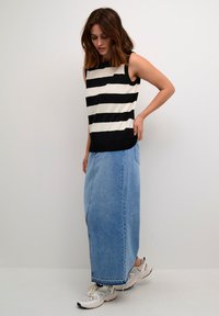 Black and white striped sleeveless top paired with a long light blue denim skirt and white sneakers. Simple, casual design with distinct color contrast.