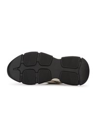 Suela de zapato de goma negra con patrones de tracción texturizados, que presenta una punta redondeada y múltiples secciones segmentadas para mayor estabilidad.
