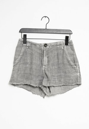 Graue Denim-Shorts mit ausgefranstem Saum, ausgestattet mit zwei vorderen Taschen und einem vorderen Knopfverschluss. Leichter Stoff mit weicher Textur.