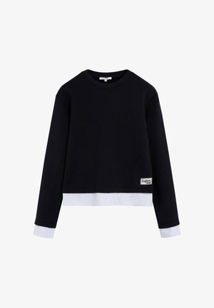 Navy cropped sweatshirt with long sleeves, white bottom band and cuffs, featuring a logo patch on the front side. Soft, smooth texture.