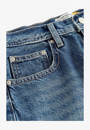 Mugavad bootcut teksad tumesinises värvitoonis. Omaduseks on keskmise kõrgusega vöökoht, vaskne tikand, eesmine tasku ja metallnupu detailid.